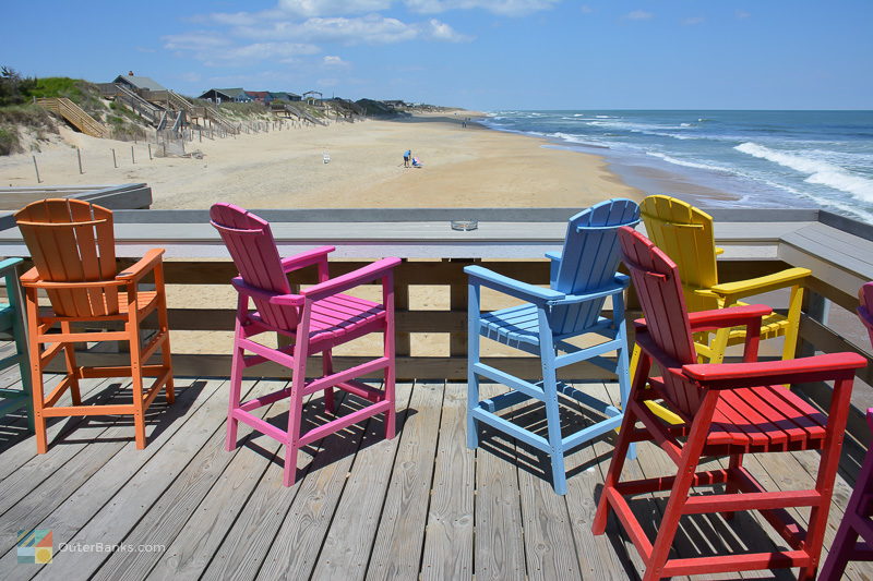Colorful chairs look over the beach at Avalon Pier 
