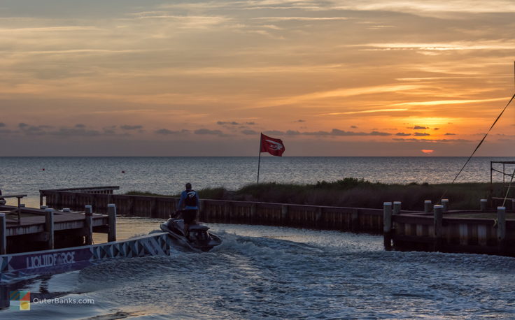 A jet ski leaves REAL Watersports in Waves at Sunset