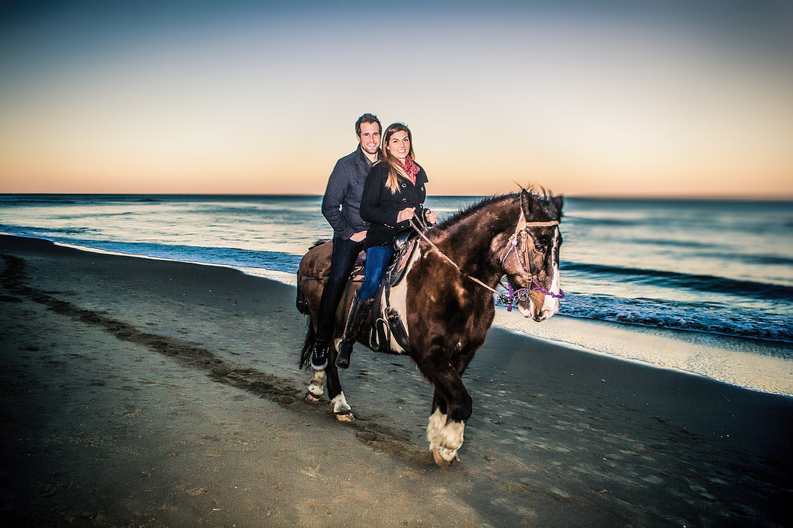 A couple on horseback with Outer Banks (OBX) Horseback