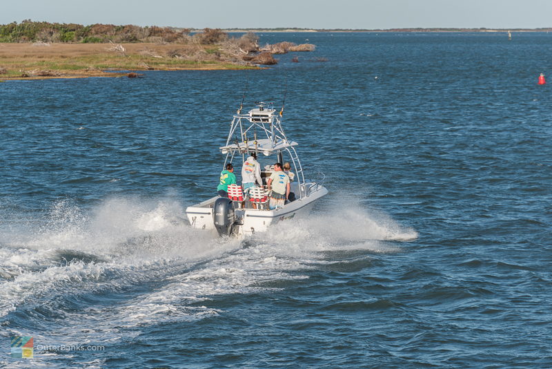 A small fishing boat leaves Hatteras Inlet