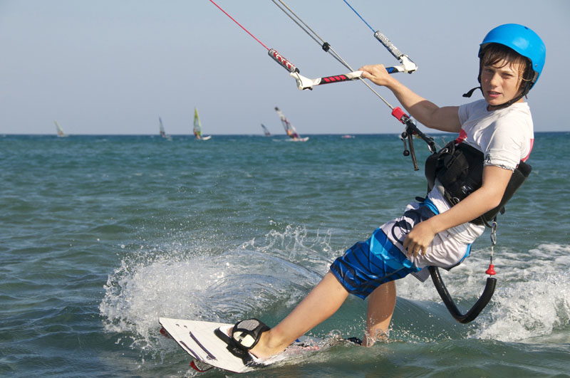 A boy learns to kite surf