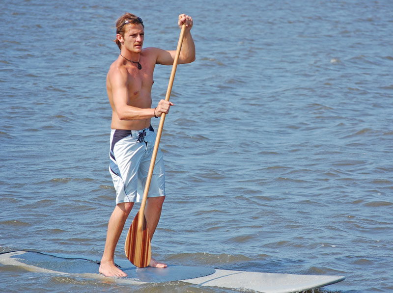 A man on a SUP (Stand Up Paddleboard)