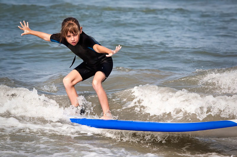 A girl surfs the Outer Banks