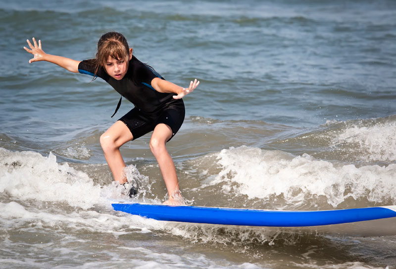 A girl learns to surf