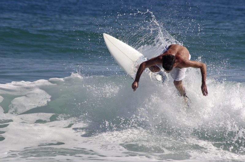 A surfer rides a wave