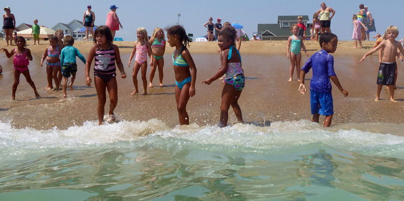 Kids swimming at the beach