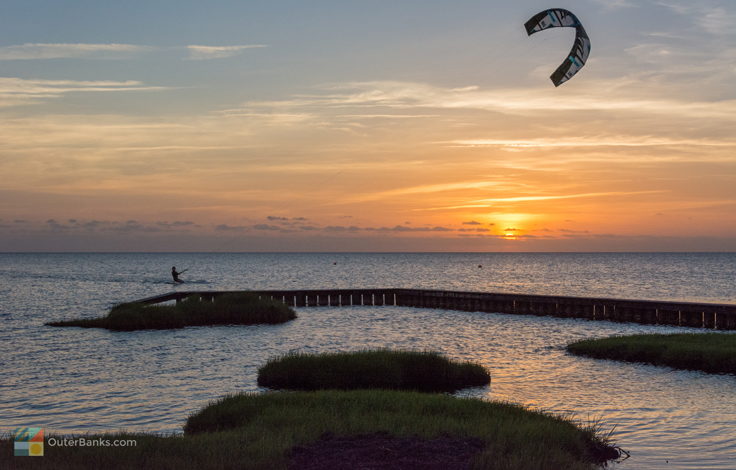 Kiteboarding at sunset in Waves