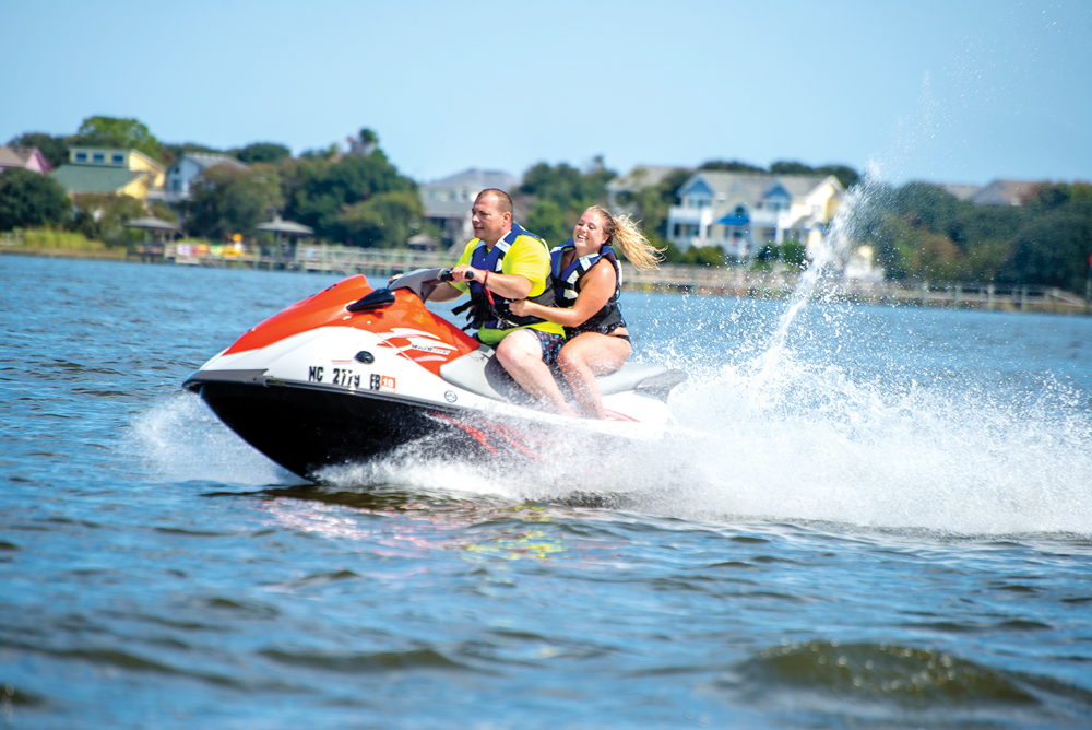 A couple jet skiing with Nor’Banks Sailing & Watersports