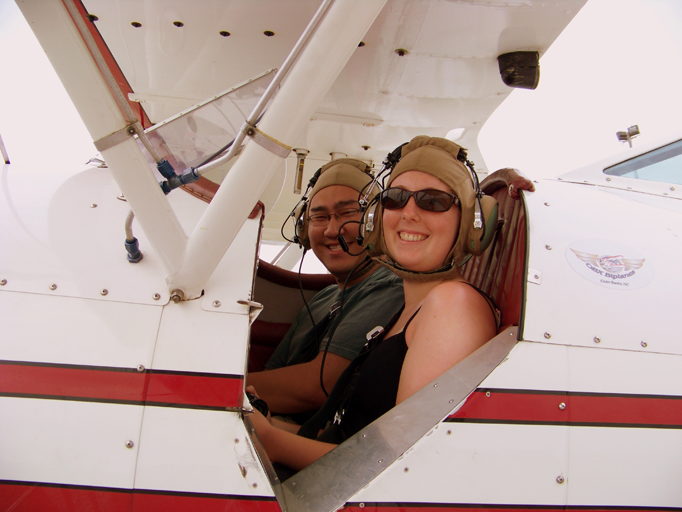 Two smiling passengers ready for their OBX Biplanes ride