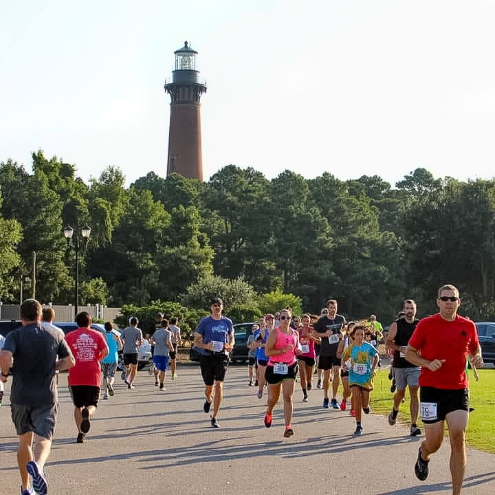 Runners under the Currituck Beach Lighthouse - OBX Running Company